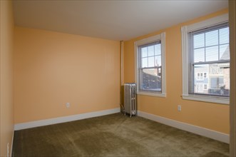 Room in empty apartment with carpet and a heater
