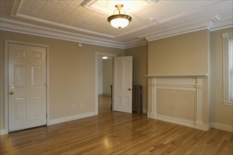 Room in empty apartment with hardwood floor