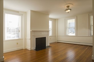 Empty room in apartment with hardwood floor and fireplace