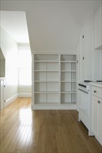 Empty room in apartment with hardwood floor and bookcase
