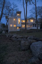Contemporary shingle style home at dusk