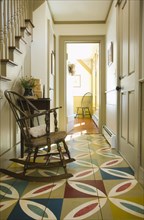 Hallway in colonial home with colorful wooden floor