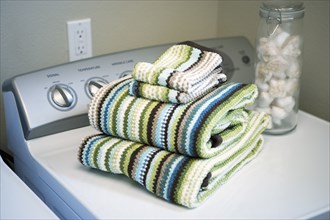 Towels folded on dryer in laundry room