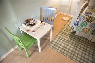 Chairs and table with a child's tea set