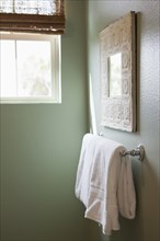 Close-up of a white towel on rail in the bathroom at home