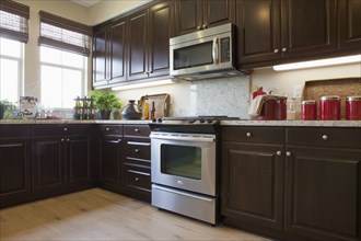 View of a kitchen having brown cabinets at home