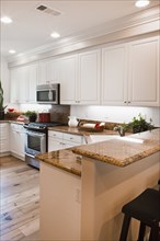 View of a kitchen having white cabinets at home