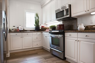 View of a kitchen having white cabinets at home