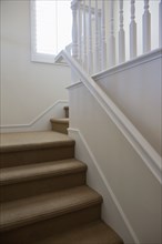 Close-up of stairs with white walls at home