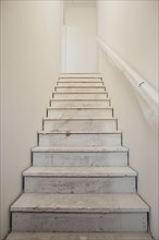 Close-up of white stairs with wall at home