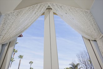 Low angle view of curtain on glass door at home