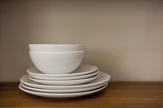 Close-up of bowls with plates in the shelf