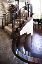 Tiled and wooden floor with stairs at home