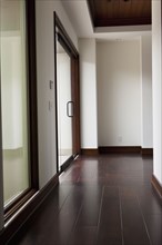 Hallway with wooden floor and closed glass door