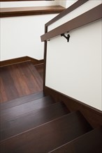 High angle view of wooden stairs with handrail at home
