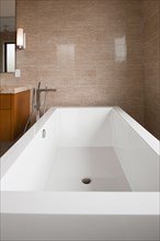 Contemporary bathroom with white bath at home
