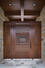 Foyer with closed wooden door