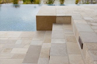 Swimming pool with stone tile stairs