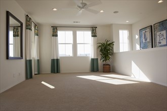 Empty room with carpet on floor and curtains on windows at home