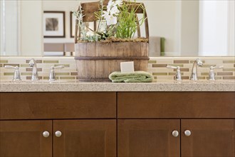 Close-up of taps with brown cabinets at home