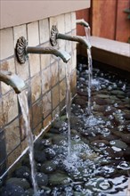Water flowing from fountains outside house
