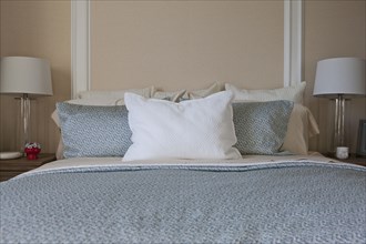 Pillows arranged on bed in middle class house