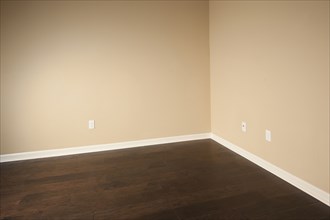 Beige wall and hardwood floor in middle class house