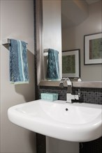 Towel rack and mirror at bathroom sink