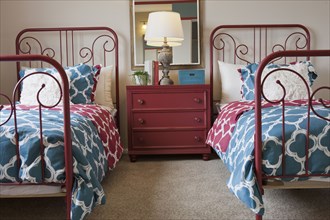 Twin beds and night table in bedroom