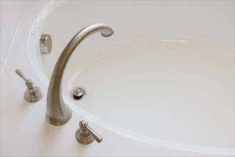High angle view of faucet and spigots at bathtub