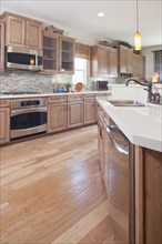 Hardwood floor and wooden cabinets in kitchen