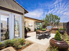 Dining area and a barbeque in backyard of house