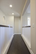 Straight hallway with white railings