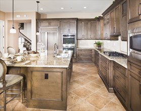 Kitchen with brown cabinets and island at home