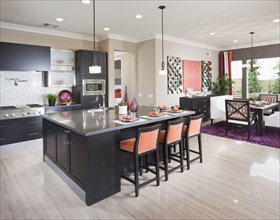 High stools at the kitchen island with dining area in background at home