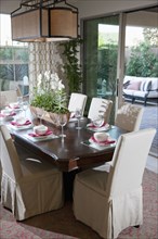 Chairs around set dining table in house