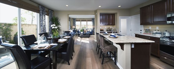 Contemporary kitchen and dining area with hardwood floors