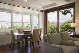 Sitting and dining area in home with downtown Hawaii city view