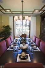 View down contemporary dining table with place settings