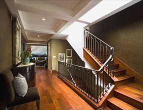 Modern hardwood staircase with wrought iron banister