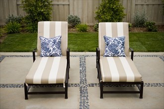Lounge chairs with throw pillows on patio