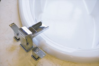 Contemporary faucet above bathtub