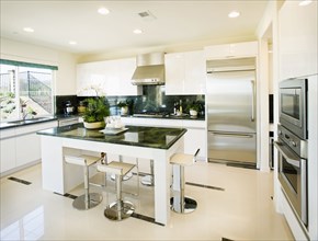 Modern white kitchen with green granite countertops