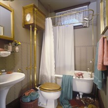 Victorian bathroom with footed tub and pull flush toilet