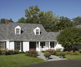 White traditional home with black shutters