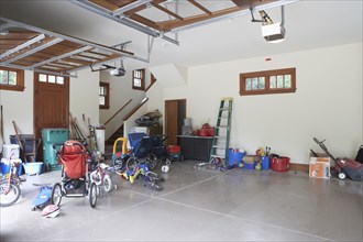 Messy garage filled  with toys and sporting equipment