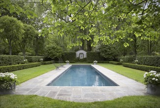 Formal shaped hedge garden with narrow pool