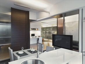 Open modern kitchen with flat screen television