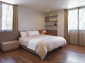 Simple minimalist bedroom with hardwood floors