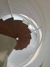 View from top down modern spiral staircase